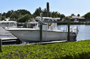 Boat lift in action, securing a large boat dockside.
